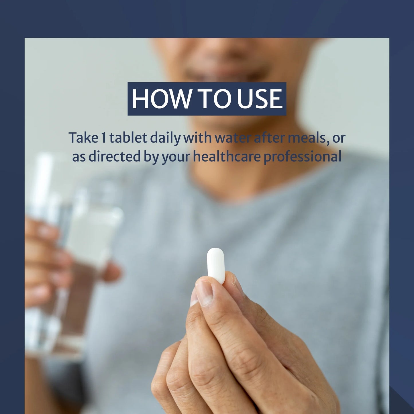 Person holding a pill with text on how to use it, against a blurred background